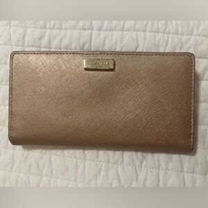Gold Kate Spade New York bifold wallet with snap closure from early 2000s.
